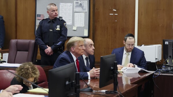 Former President Donald Trump appears during a court hearing at Manhattan criminal court, Thursday, Feb. 15, 2024, in New York. A New York judge says Trump's hush-money trial will go ahead as scheduled with jury selection starting on March 25. (Brendan McDermid/Pool Photo via AP)